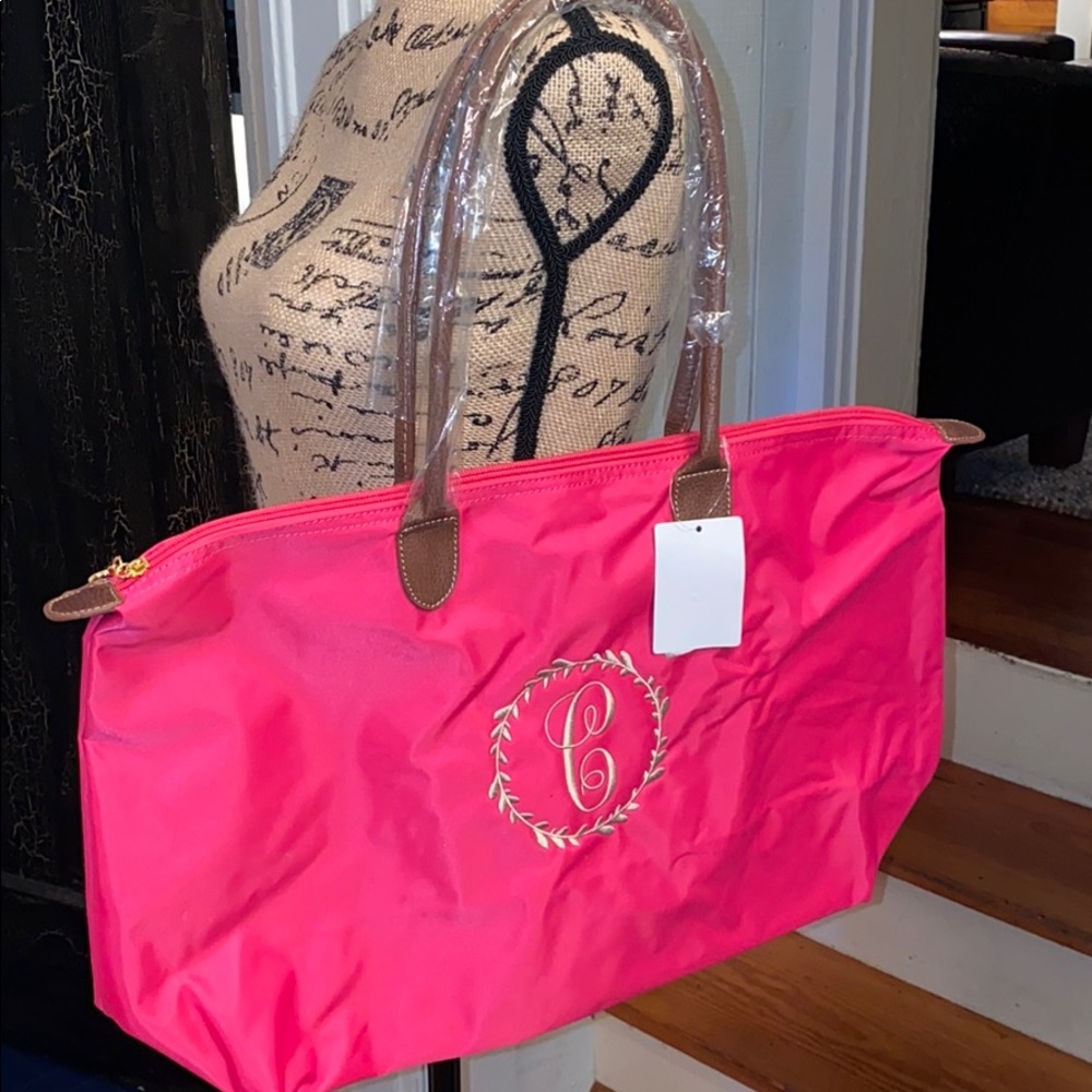Dark pink tote bag with tan embroidery
